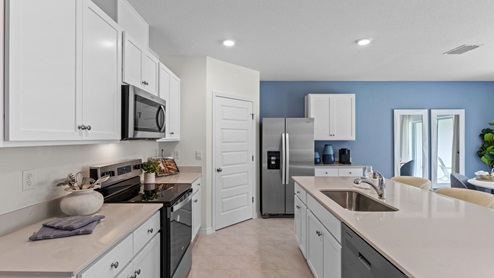 Open kitchen area with stainless-steel appliances
