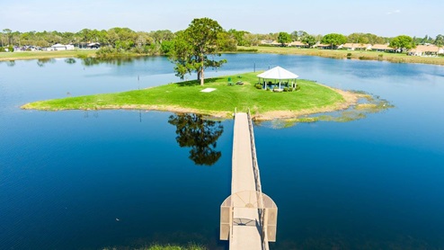 walking bridge to a small island with a pavilion
