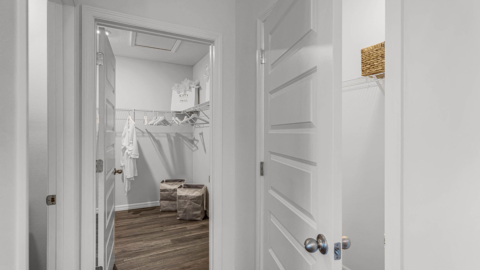 Primary closet with vinyl flooring