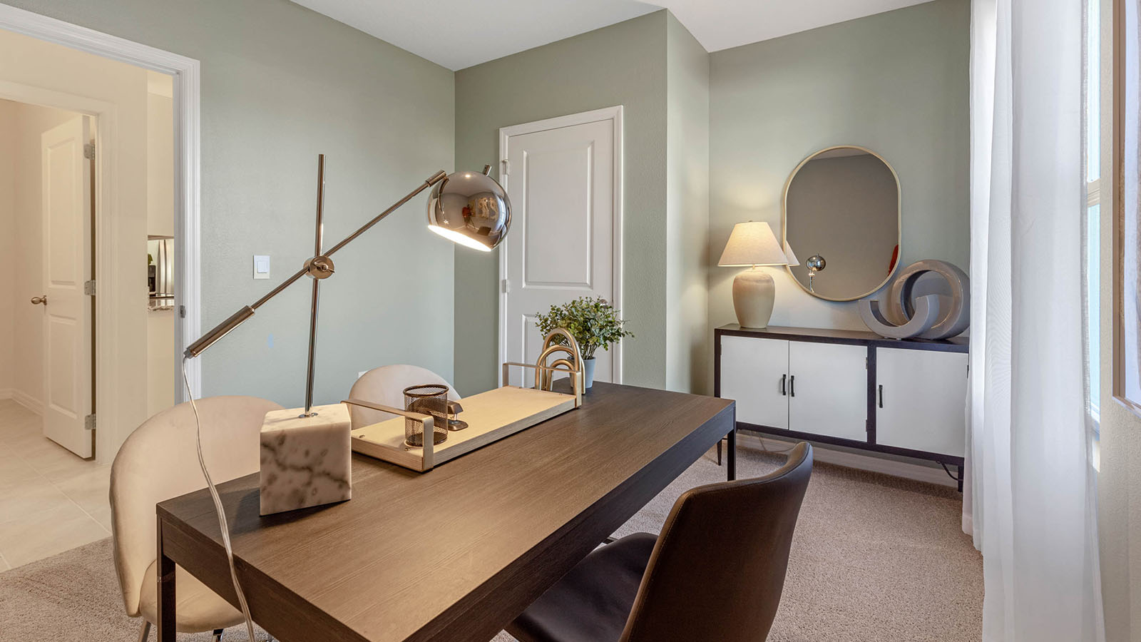 Guest bedroom staged as an office with desk and cabinet