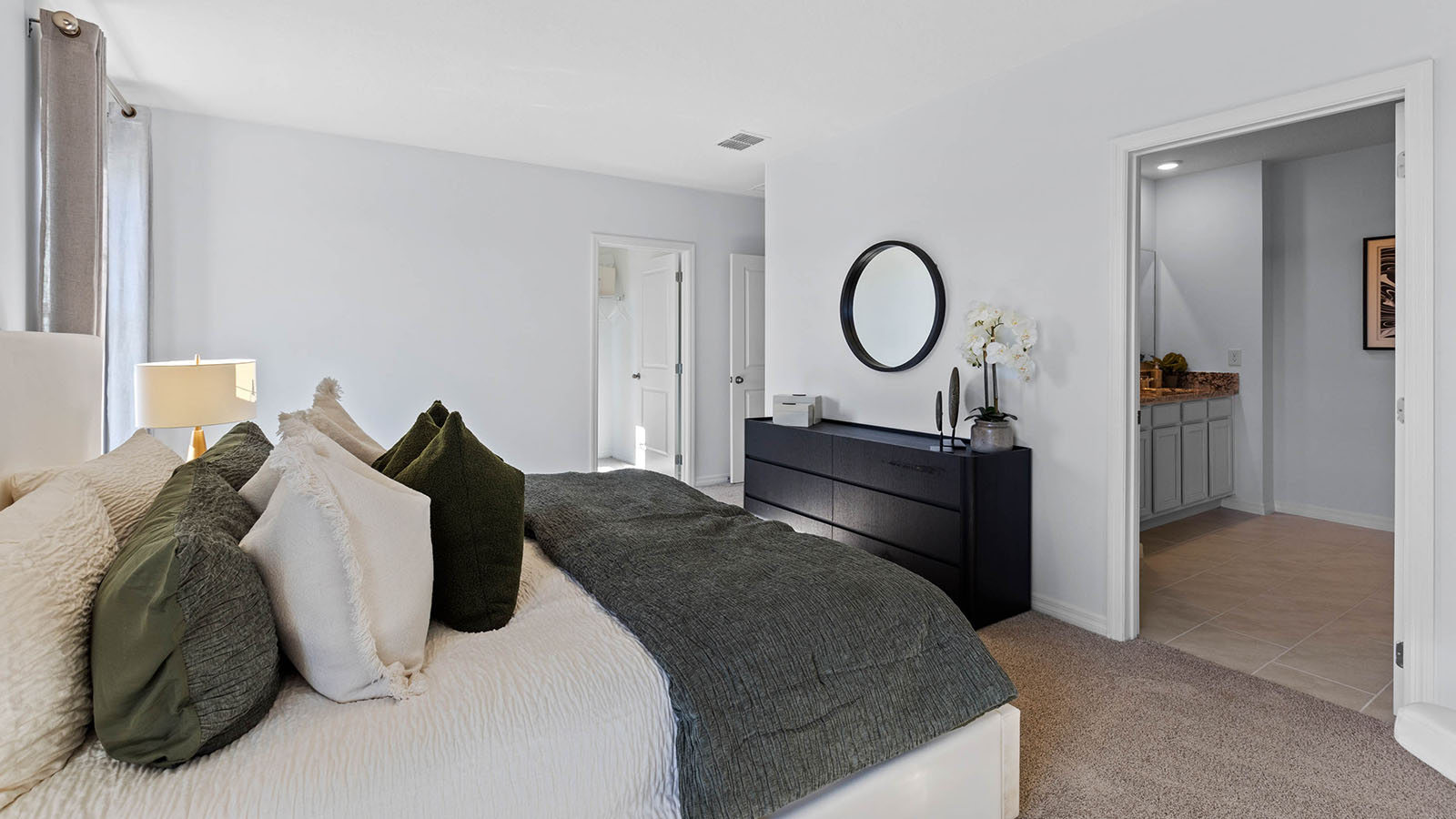 Primary bedroom with attached bathroom and walk in closet