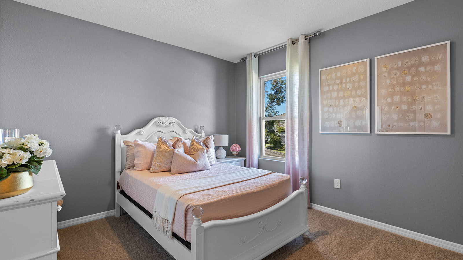 Guest bedroom staged as kids room with full size bed and dresser