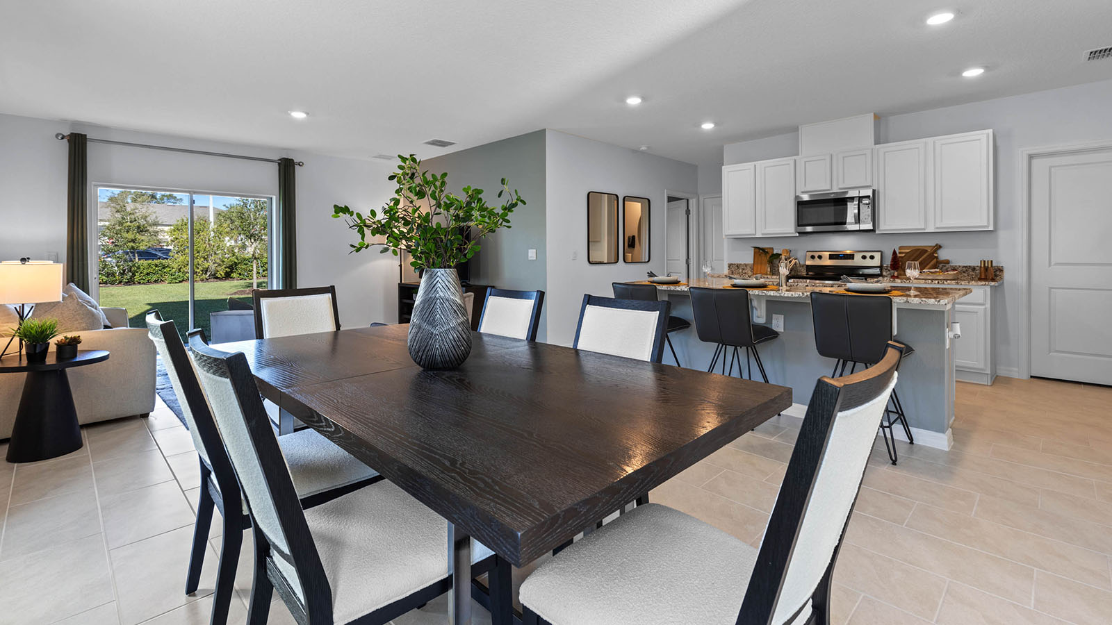 Open concept living spaces of dining room, kitchen and living room