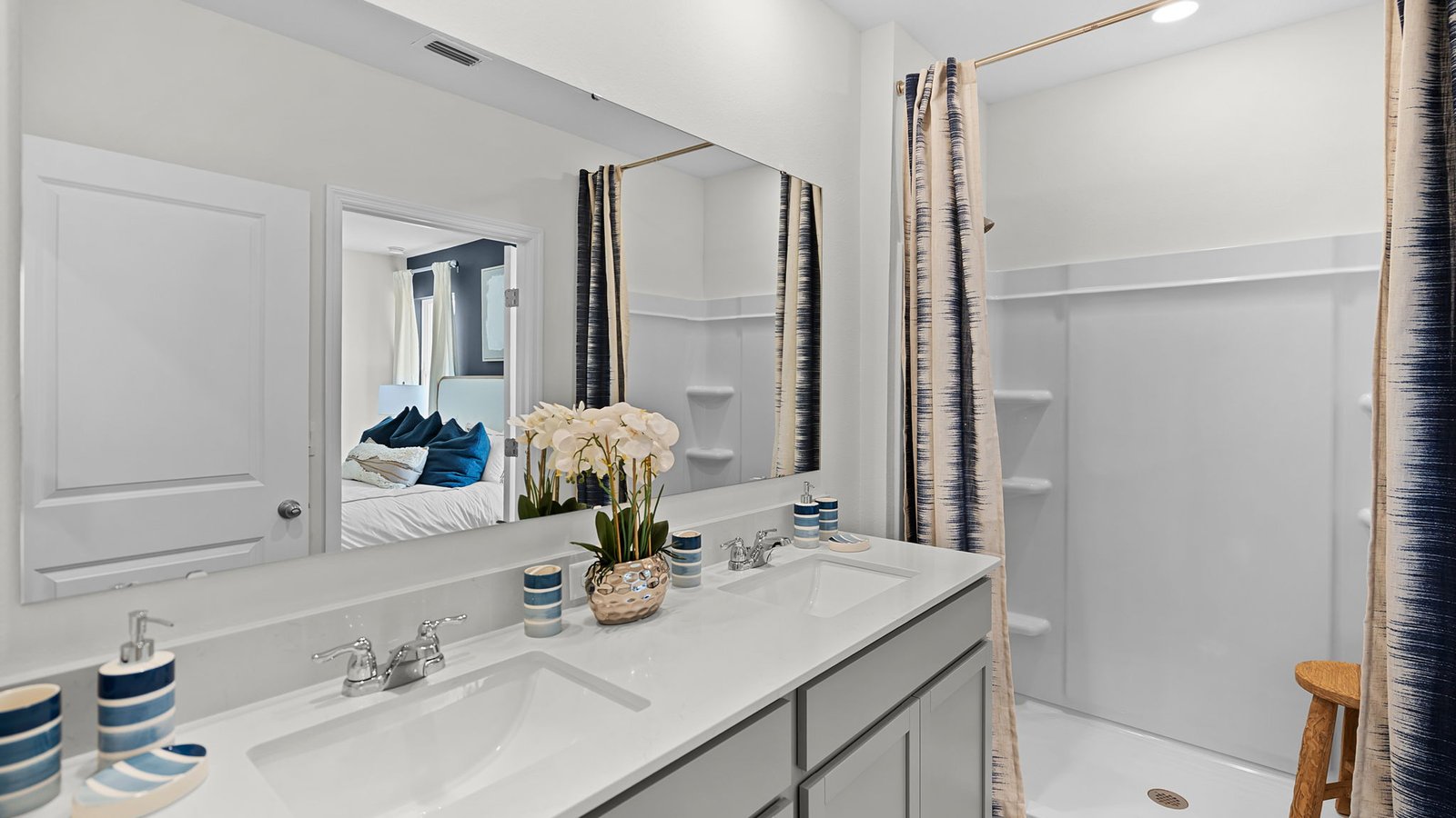 Primary bathroom with dual vanity sinks and walk-in shower