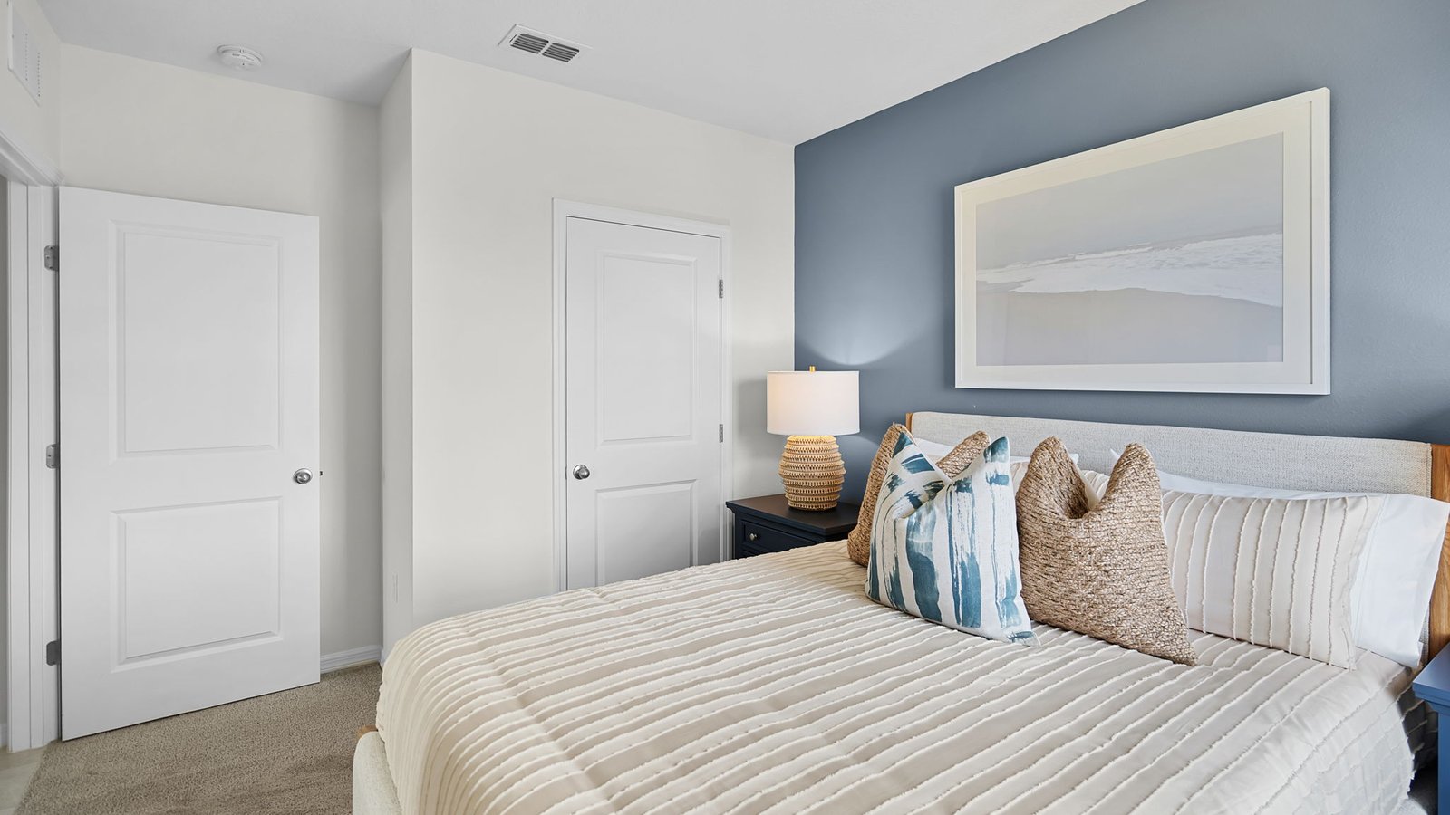 Guest bedroom with closet and queen size bed