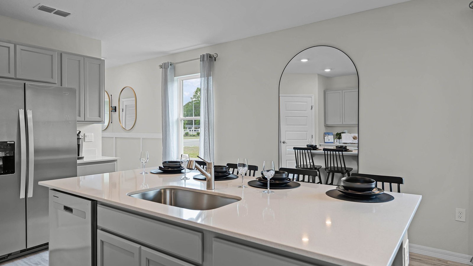 Kitchen island with stainless steel sink and fridge
