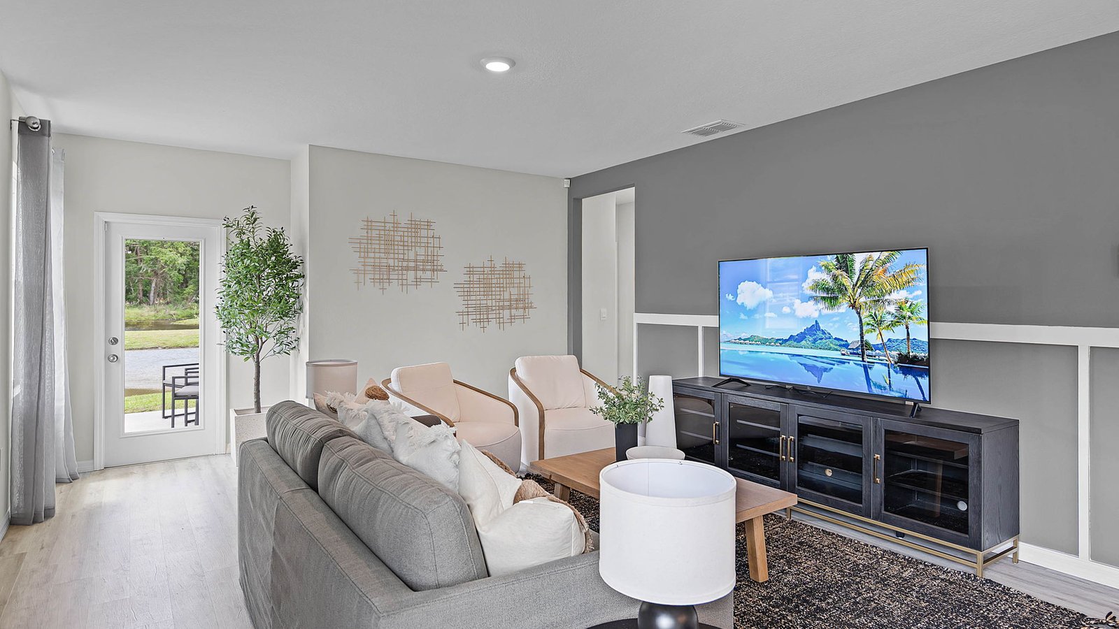Living room decorated with couch, tv stand and decor