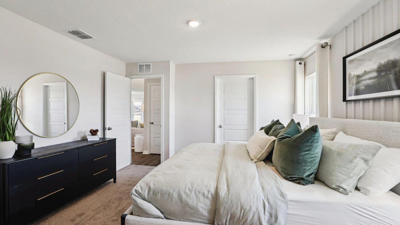 Primary bedroom decorated with green accents