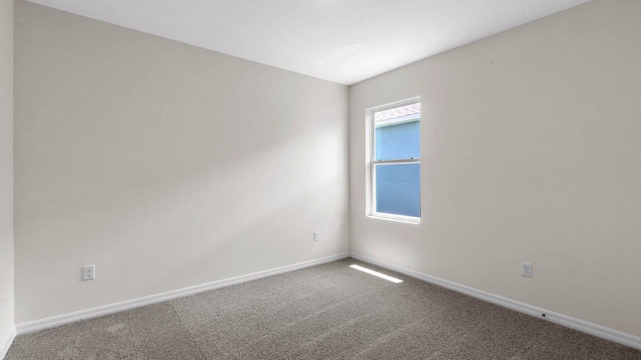 second guest bedroom unfurnished with carpet throughout