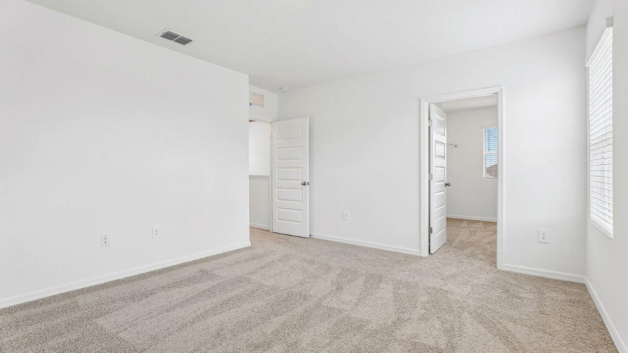 Primary bedroom with carpet flooring