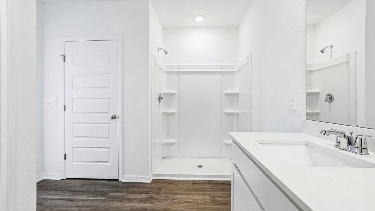 Primary bathroom with walk-in shower and linen closet