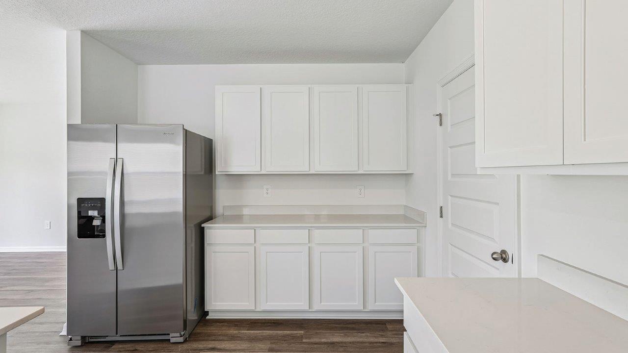 Kitchen with ample counter space and stainless steel fridge