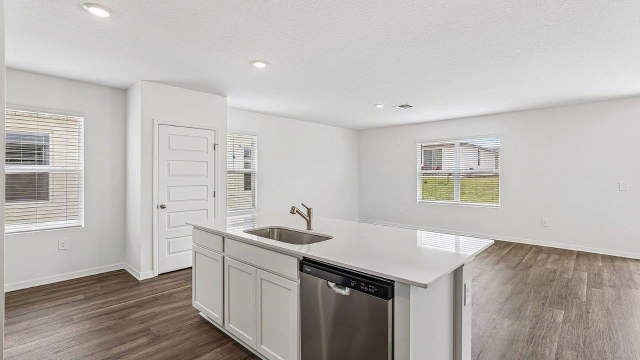 Kitchen island and pantry viewing the living room