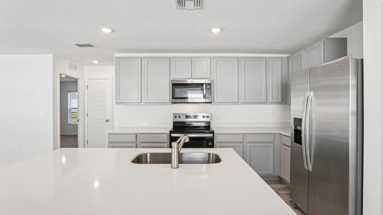 Kitchen with floating shelf and appliances