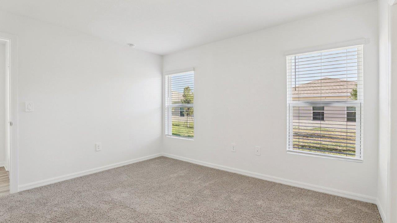 Primary bedroom with carpet flooring