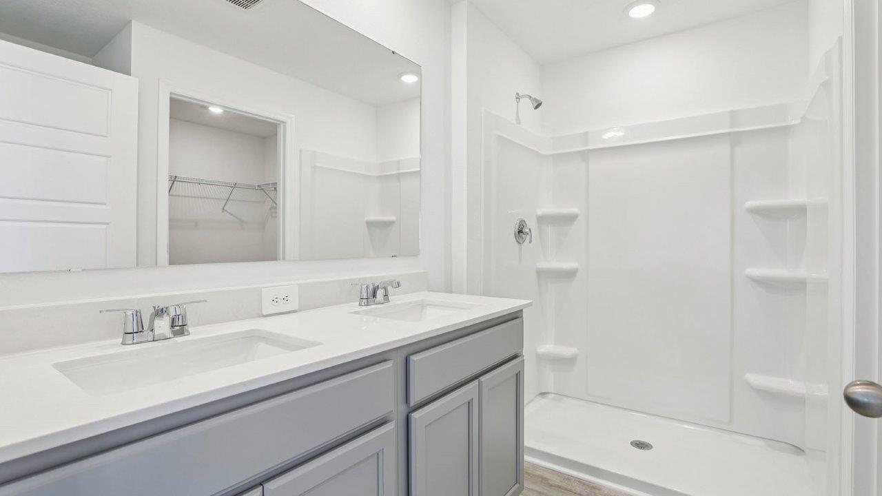 Primary bathroom with dual vanity sinks
