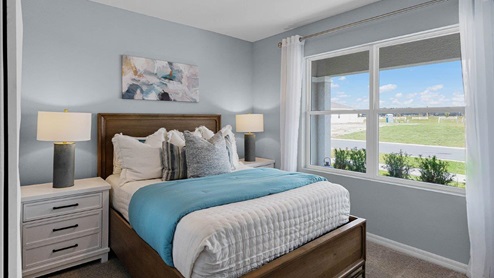 Guest bedroom with large windows and carpet