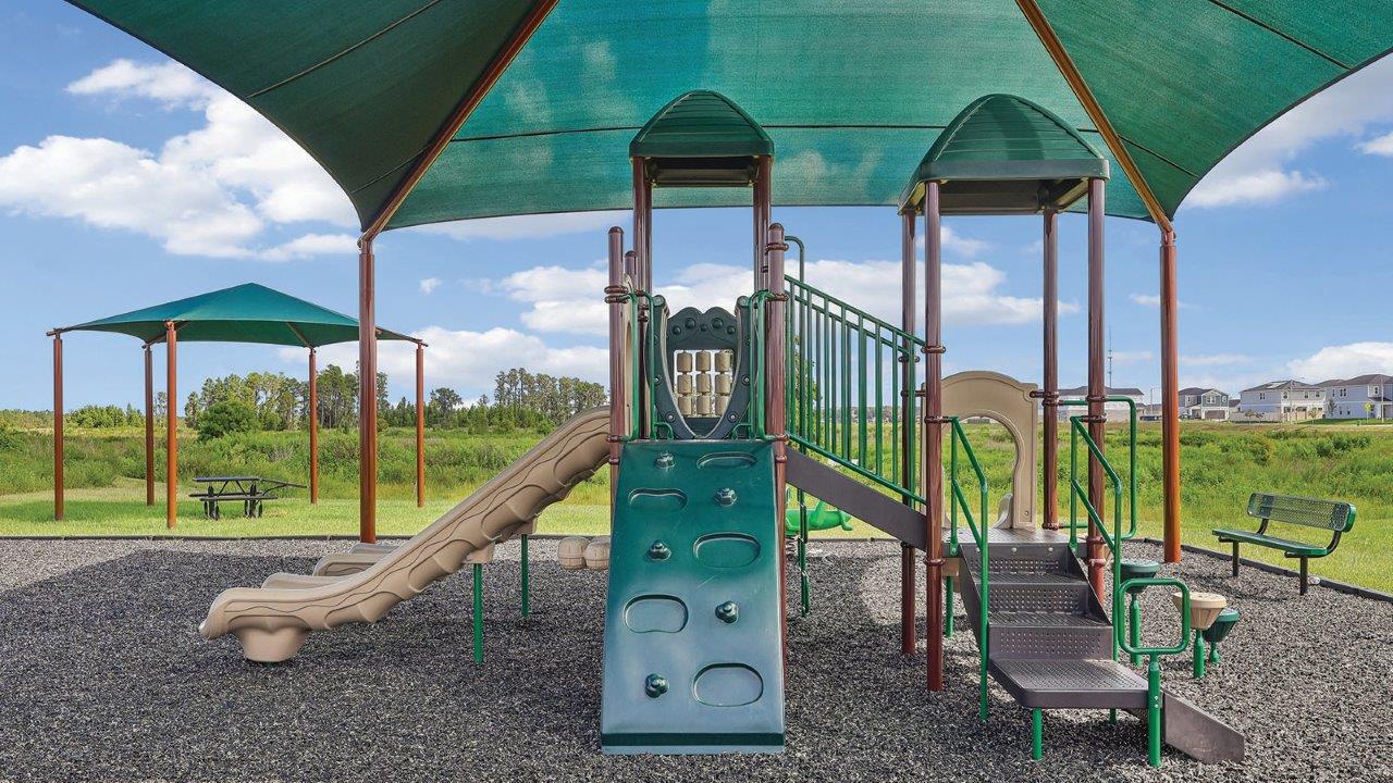 playground with slide and canopy and picnic table