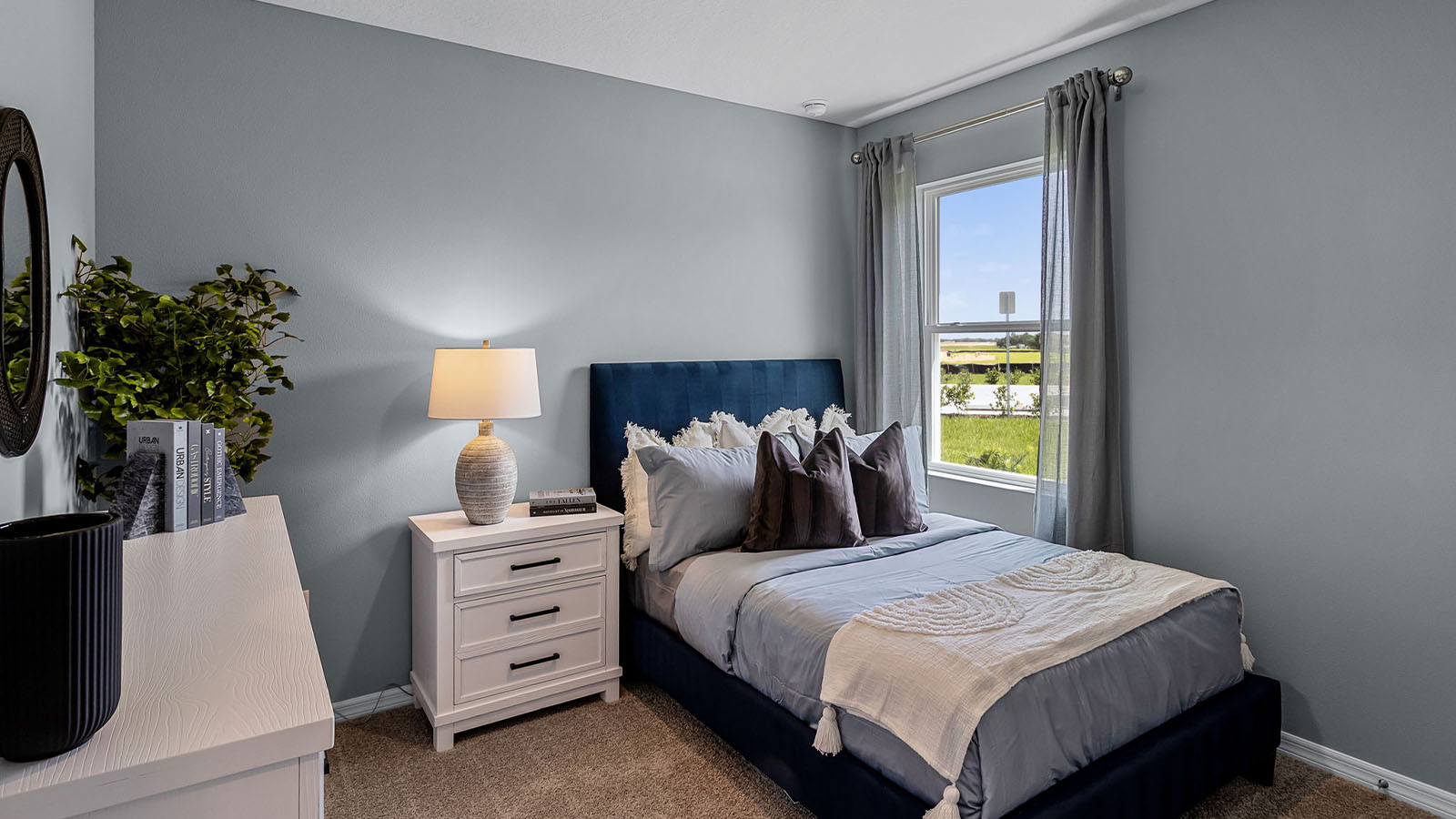 guest bedroom with twin bed and carpet flooring