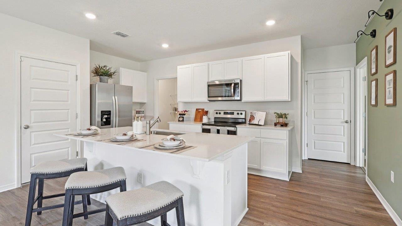 Kitchen with quartz countertops and white cabinets