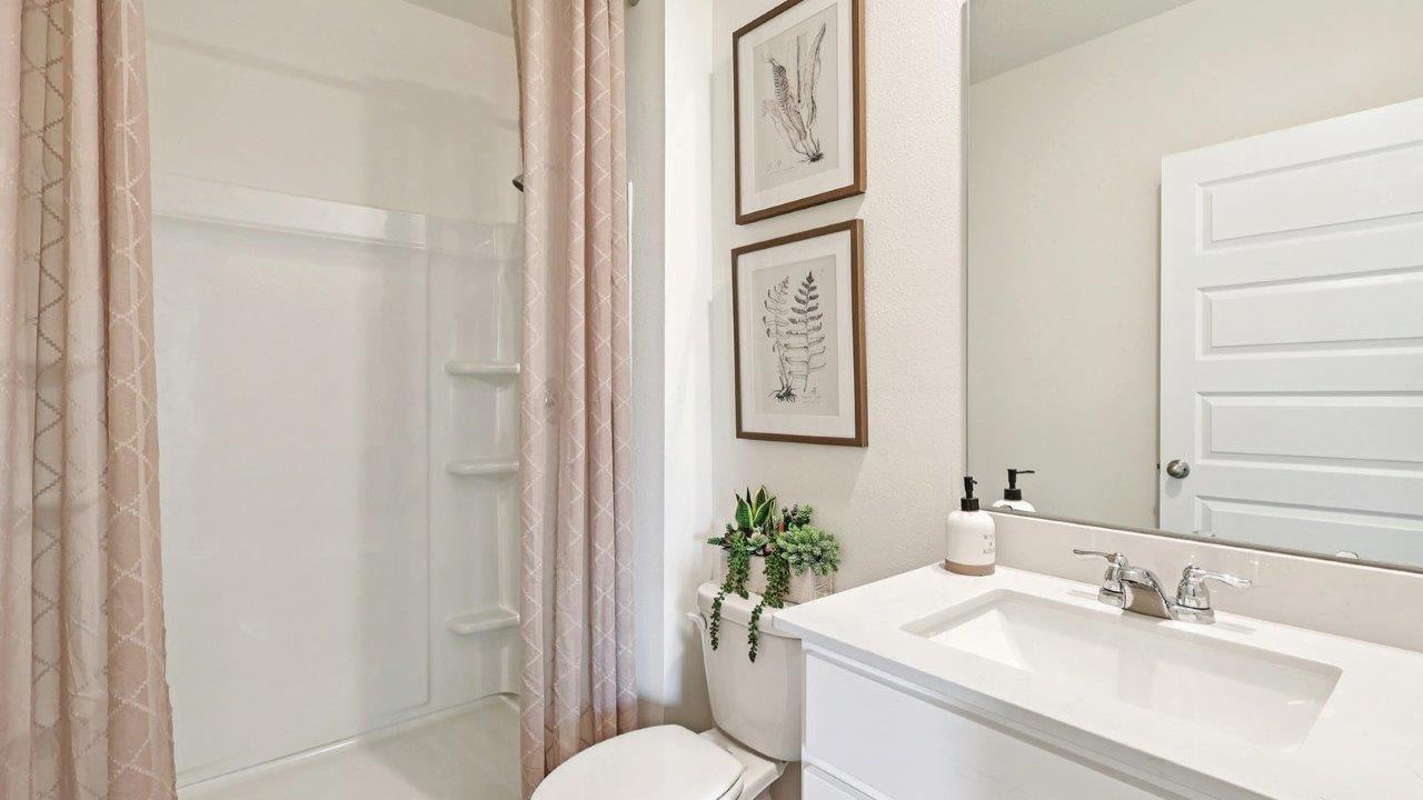Guest bathroom with single sink vanity and shower