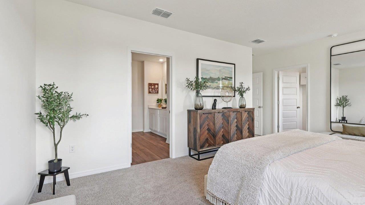 Primary bedroom with view of the en-suite bathroom