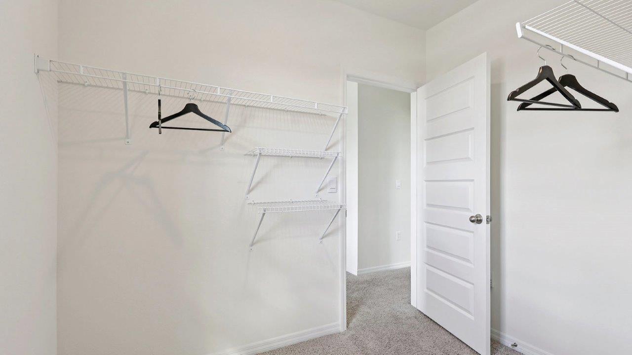 Primary bedroom closet with wire racks