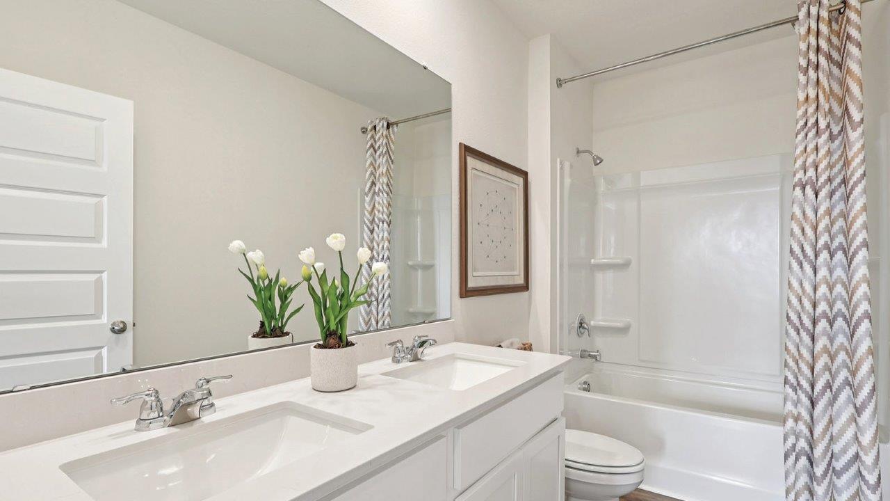 Guest bathroom with dual vanity sink and tub