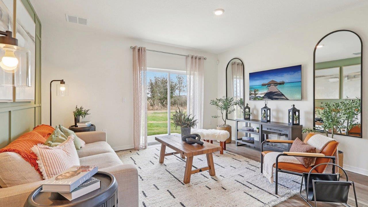 Living room with couch and chairs and wall art