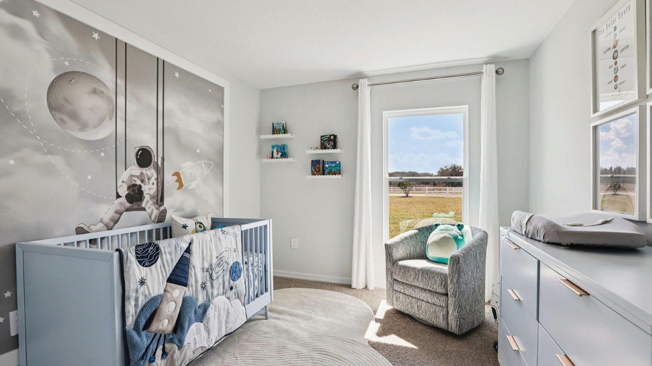 Nursery with crib, chair and dresser
