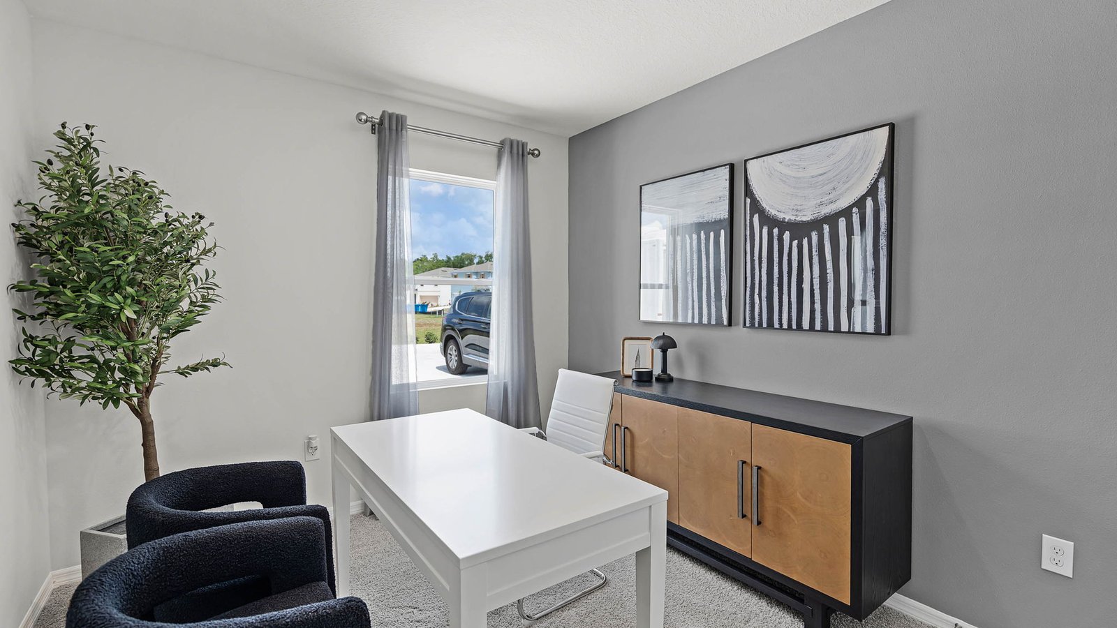 guest bedroom converted into an office with carpet throughout