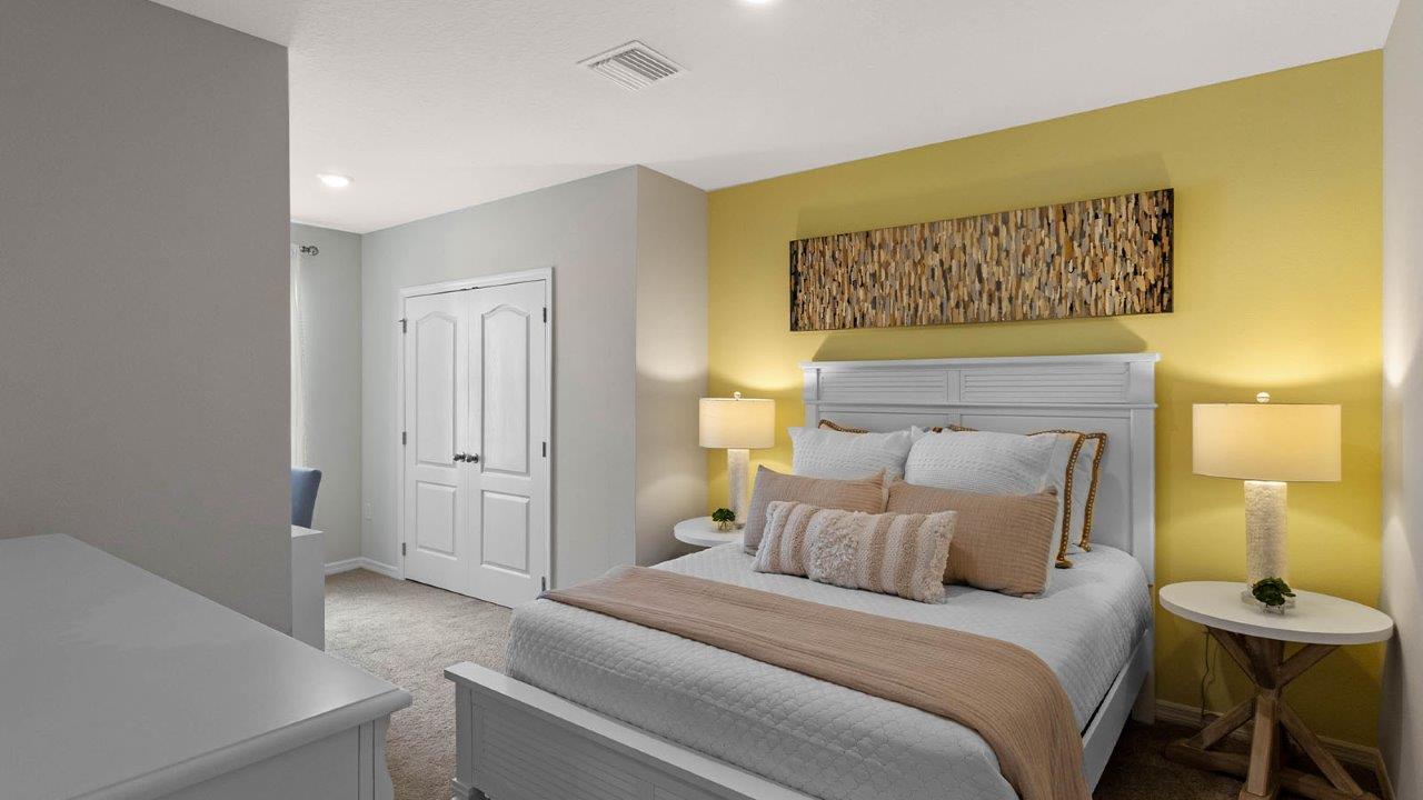 Guest bedroom with yellow wall and full size bed