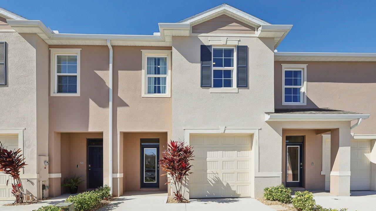 Exterior townhome with single car garage and driveway