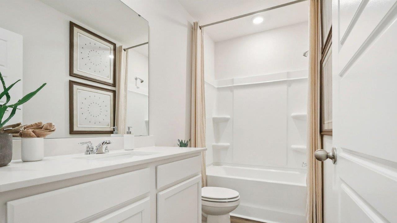 Guest bathroom located upstairs with tub