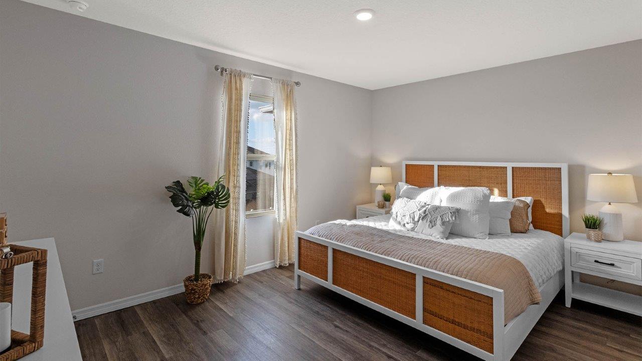 Primary bedroom with king size bed and luxury vinyl plank floors