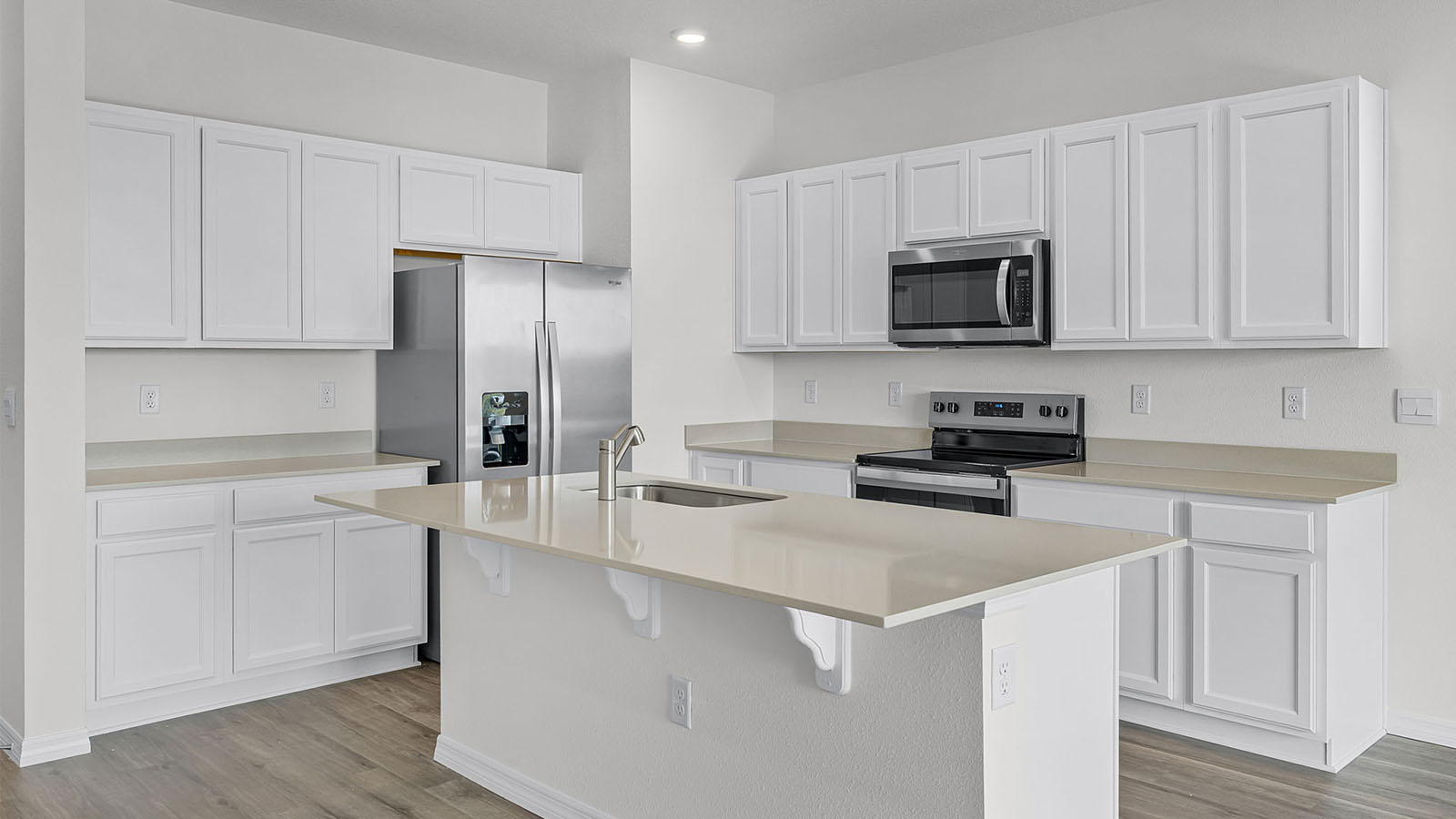 Kitchen Island with Luxury vinyl flooring and stainless steel appliances