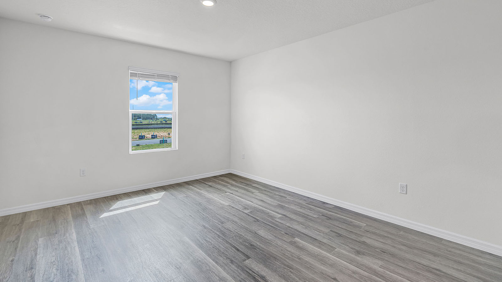 Primary bedroom with luxury vinyl planks