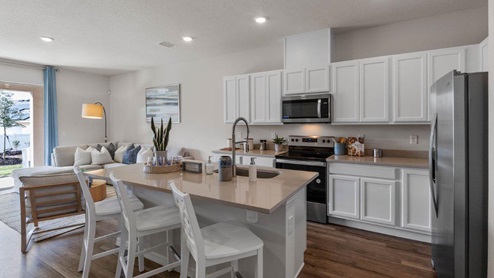 Kitchen view with island and quartz countertops