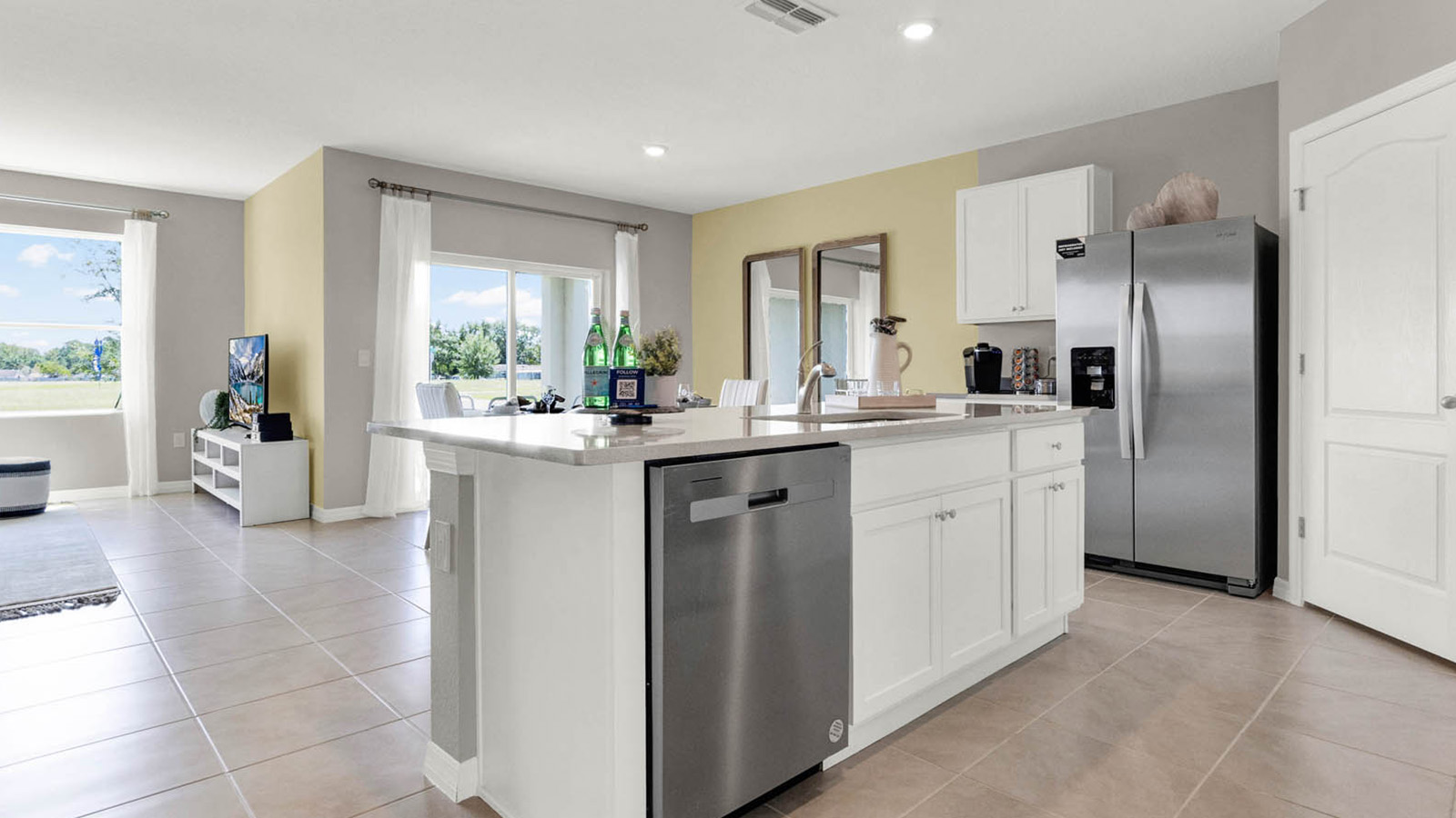 View of the kitchen island with dishwasher overlooking the dining room