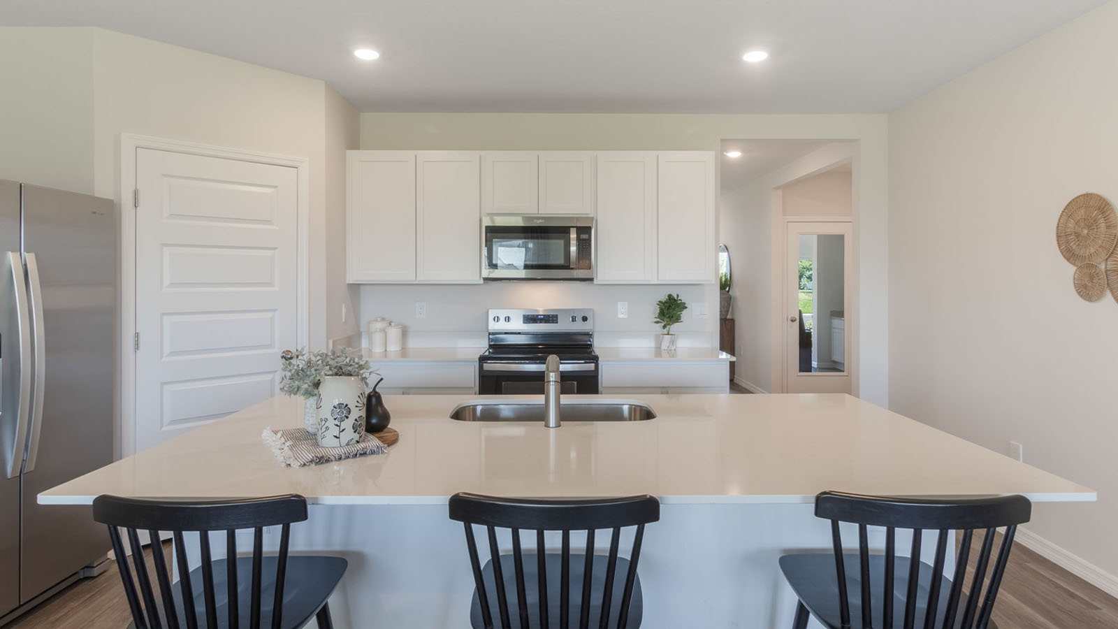 Kitchen island near the hallway leading to the entry way