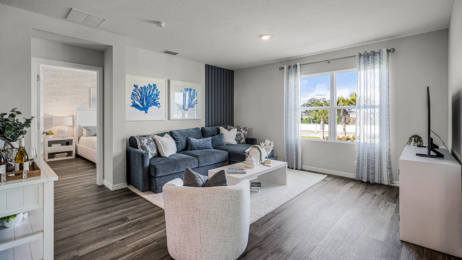 Living room with the primary bedroom behind and Luxury vinyl flooring