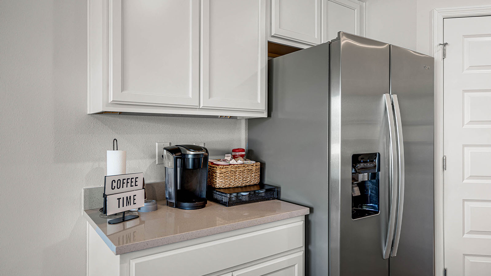 Stainless steel fridge and quartz countertops
