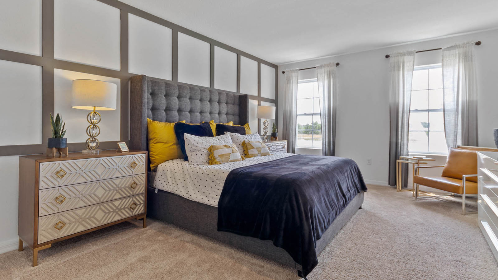 Primary bedroom with bed and spare chair