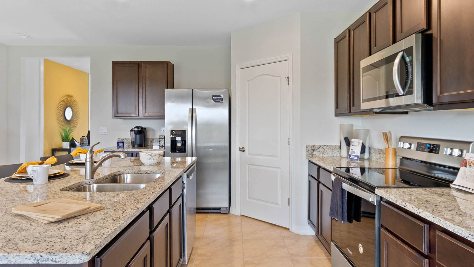 Kitchen with island and stove, microwave and fridge