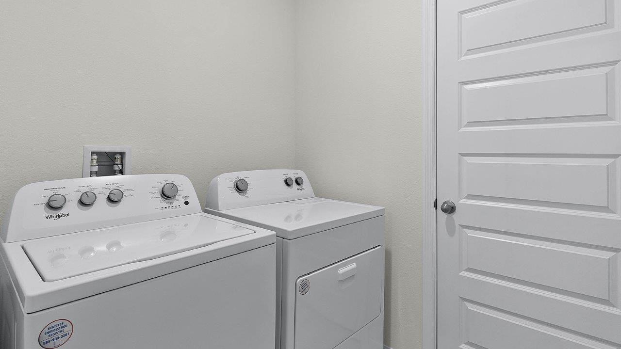 centrally located laundry room with washer and dryer