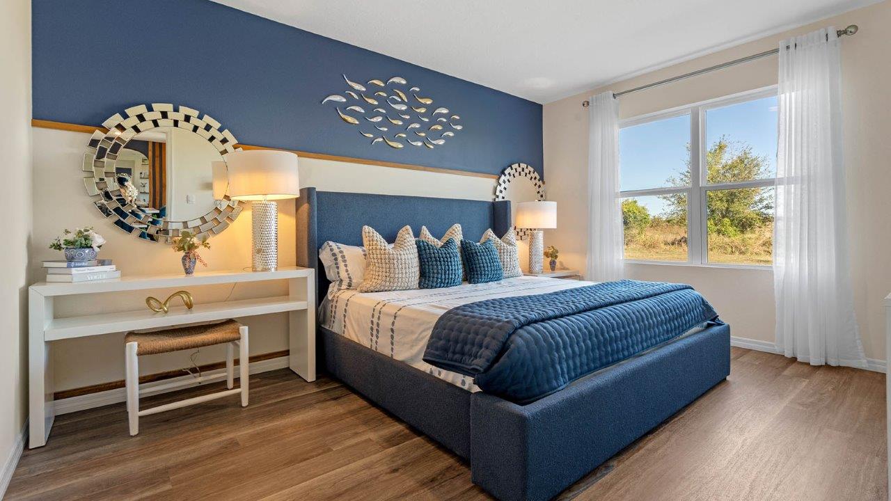 Primary bedroom with king size bed and vanity