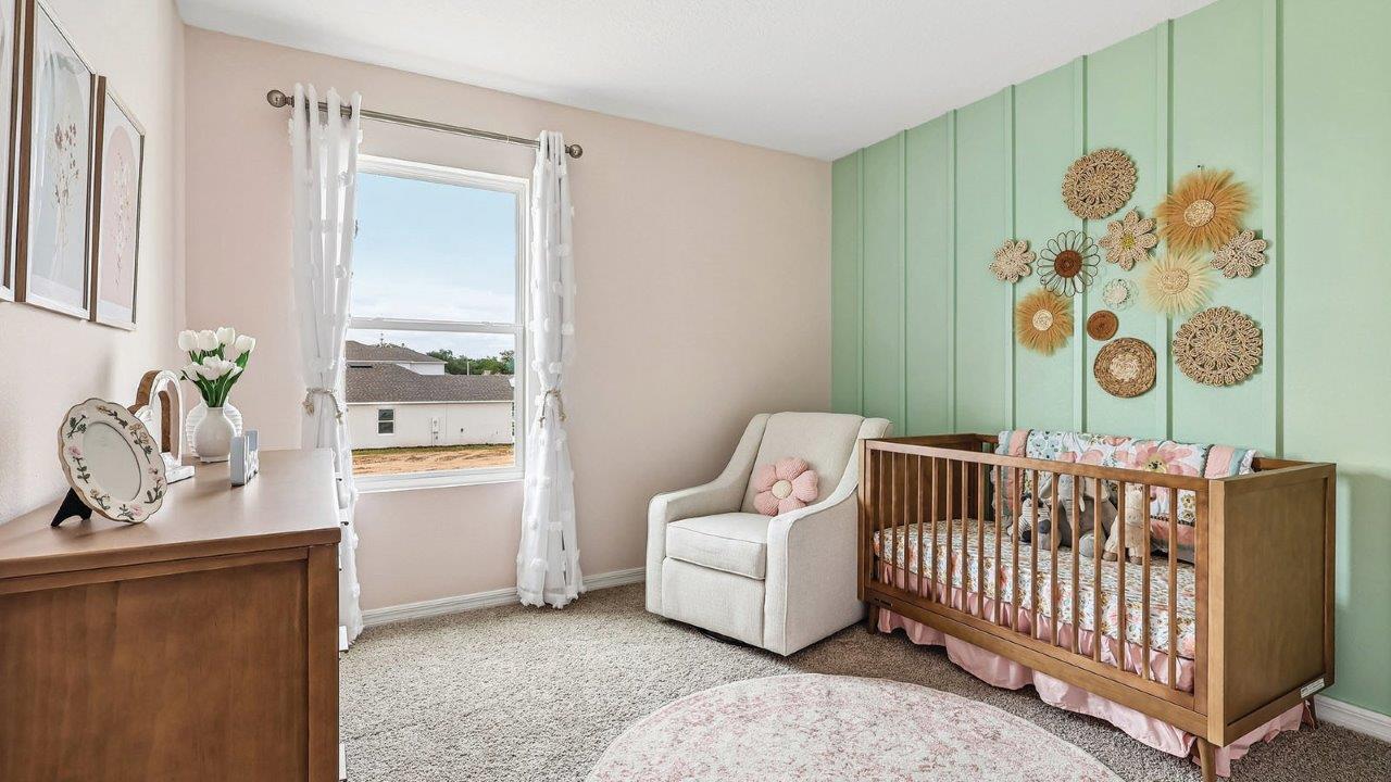 Nursery with crib, chairs and dresser