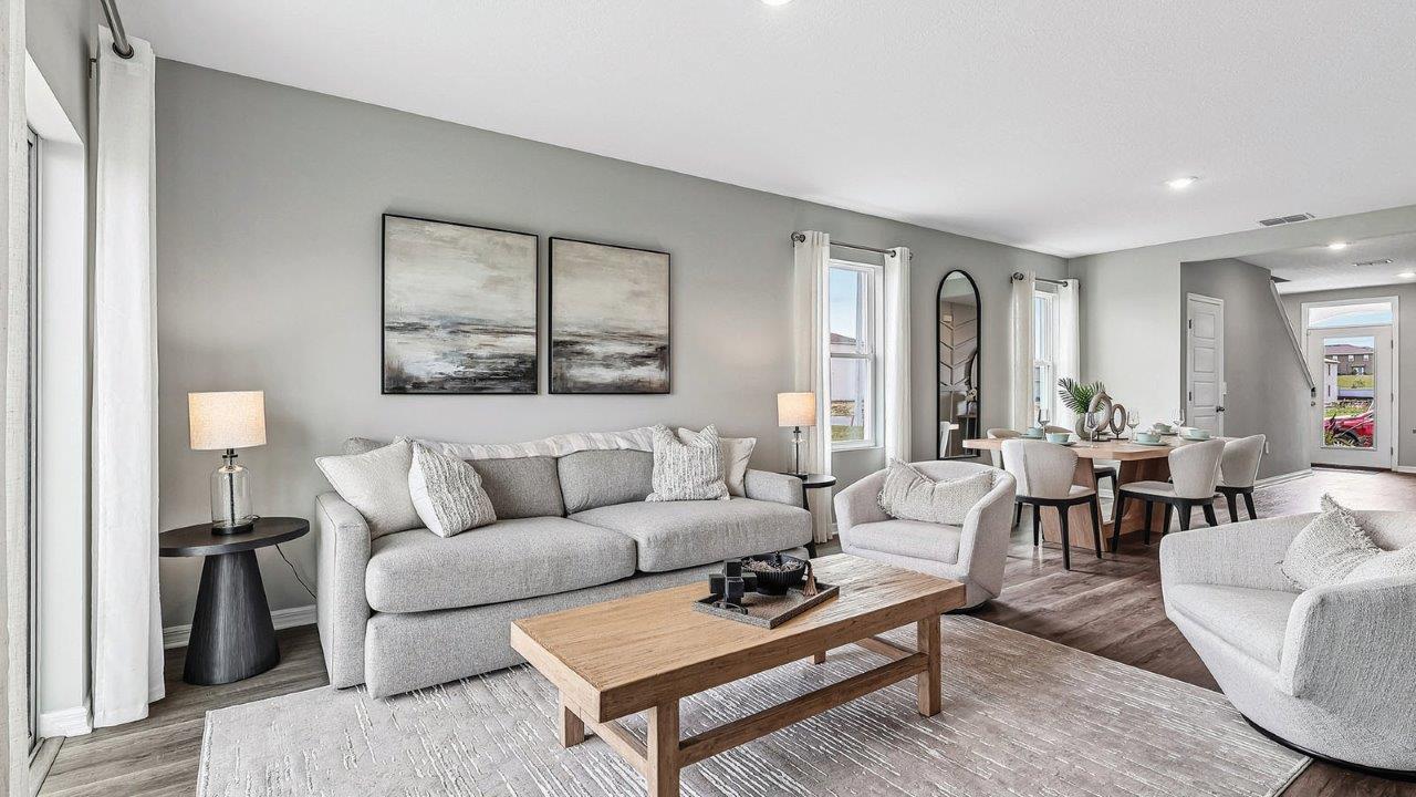Living room with couch and chairs and wall art