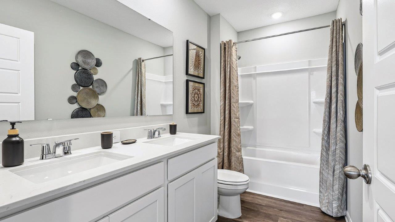 Upstairs bathroom with dual sink and tub