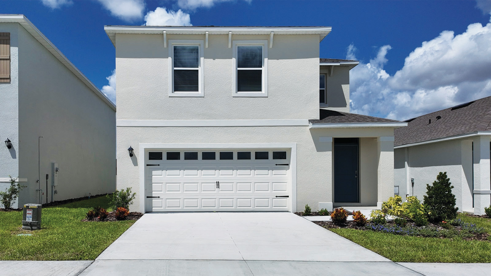 Exterior two story single family home with two car garage